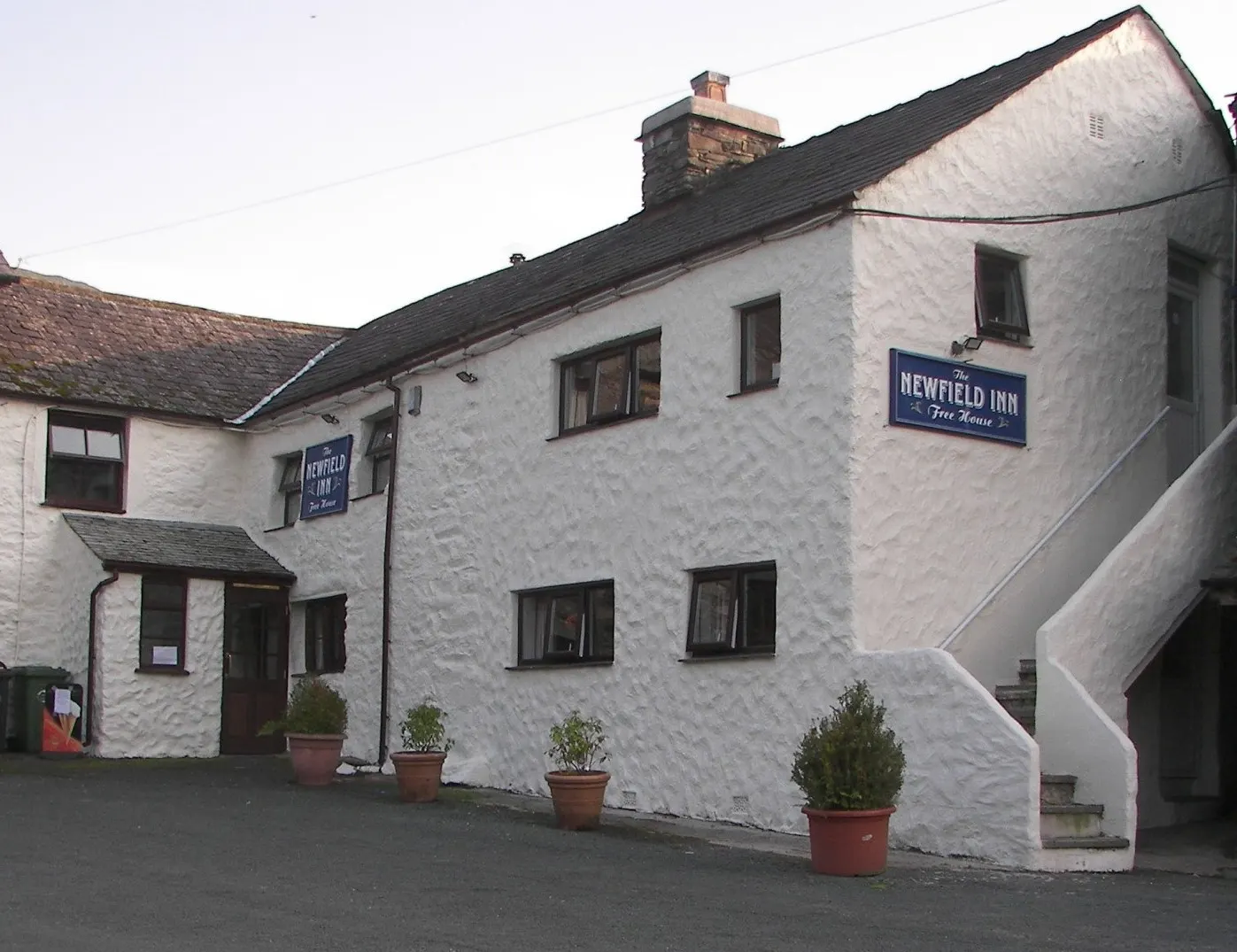 The whitewashed front of the Newfield Inn
